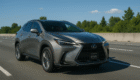 2025 Lexus NX 350h luxury SUV driving on highway near Vancouver on sunny day
